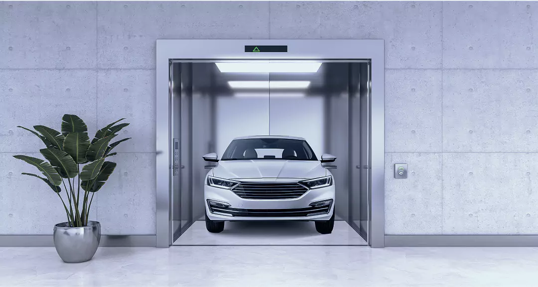 Modern car lift facility at a commercial hub for rent in Delhi NCR with a white sedan inside.