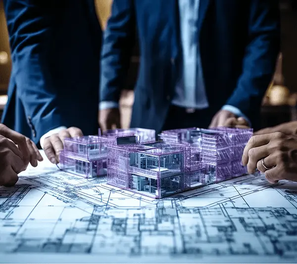 JMJ Estate commercial real estate developers reviewing architectural blueprints and 3D building models.